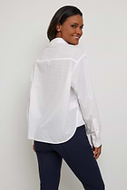 The Best Travel Top. Woman Showing the Back Profile of a Kieran Top in White.