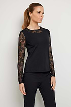 The Best Travel Top. Woman Showing the Side Profile of a Kim Camo Mesh Top in Black.
