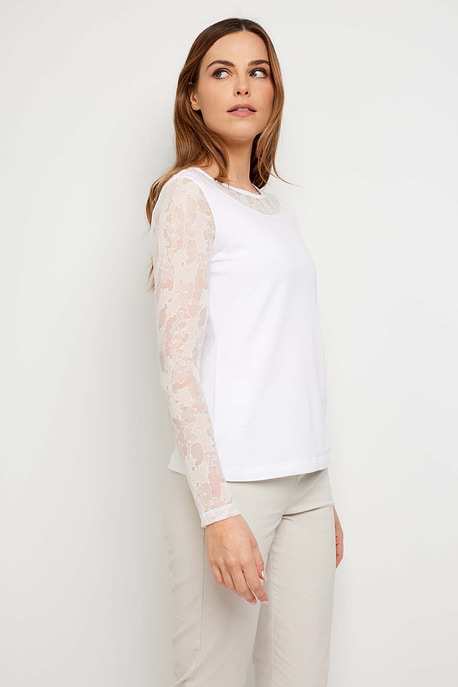 The Best Travel Top. Woman Showing the Side Profile of a Kim Camo Mesh Top in White.
