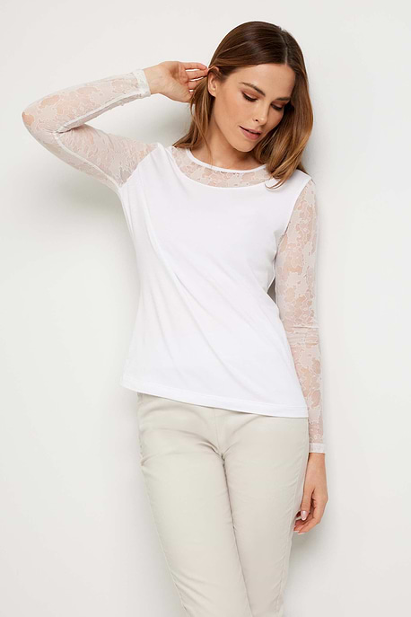 The Best Travel Top. Woman Showing the Front Profile of a Kim Camo Mesh Top in White.
