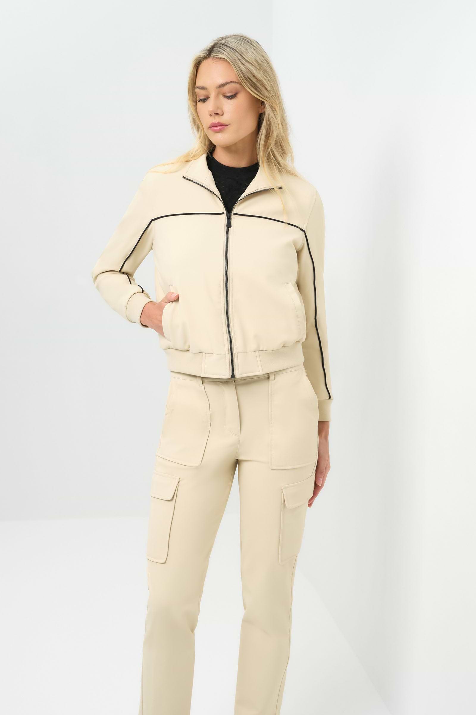 Font view of cream bomber jacket with black pinstripe detailing zipped up to collar