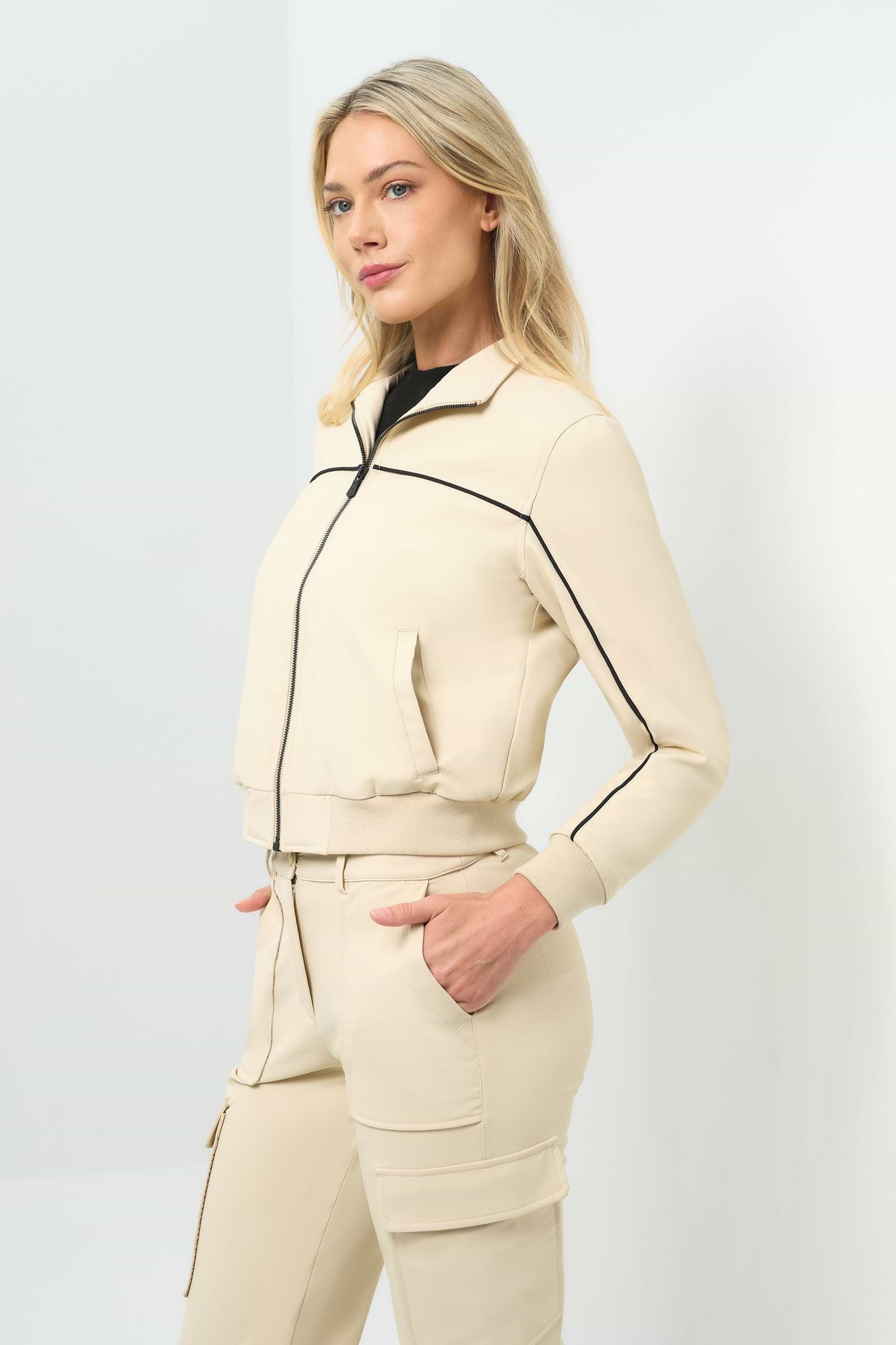 Side view of cream bomber jacket with black pinstripe detailing zipped up to collar