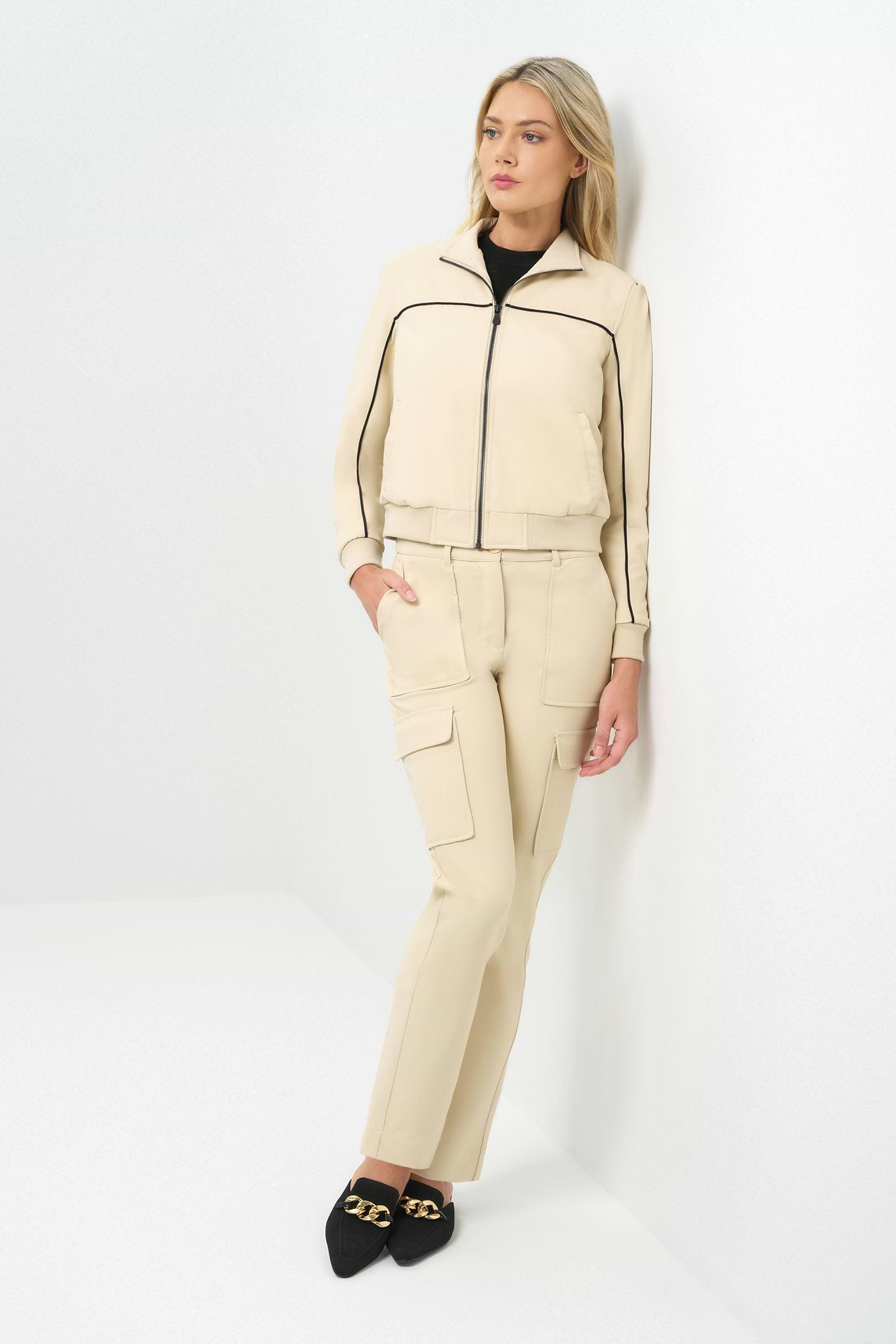 Full body view of cream bomber jacket zipped up with matching cargo patch pocket pant