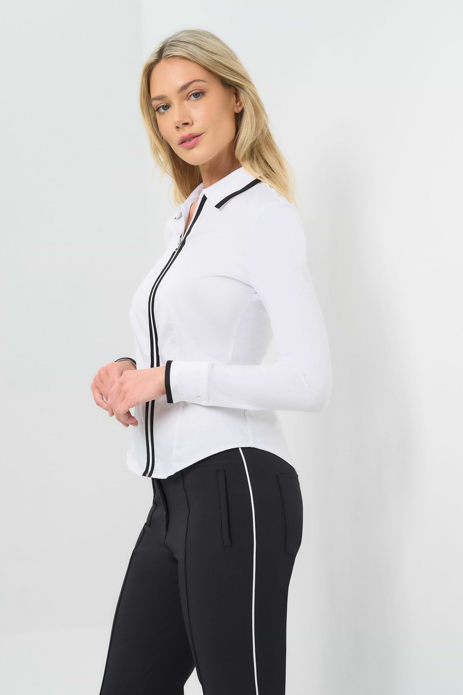 Side view White long-sleeve zip-front blouse featuring a contrasting black trim along the collar, zipper placket, and cuffs.