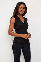 The Best Travel Top. Woman Showing the Side Profile of a Madelyn Top in Black.