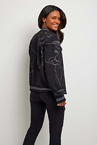 The Best Travel Jacket. Man and Woman Showing the Back Profile of a Map Bomber Jacket in Black.