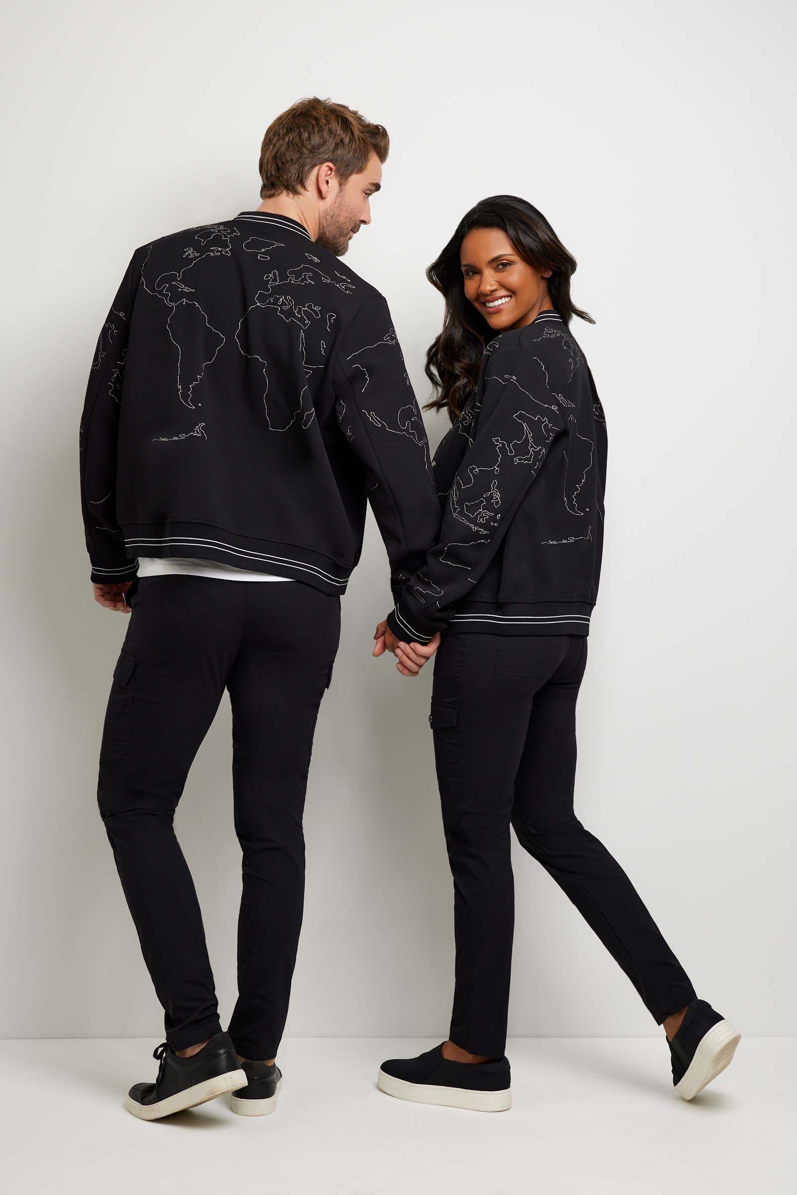 The Best Travel Jacket. Man and Woman Showing the Back Profile of a Map Bomber Jacket in Black.