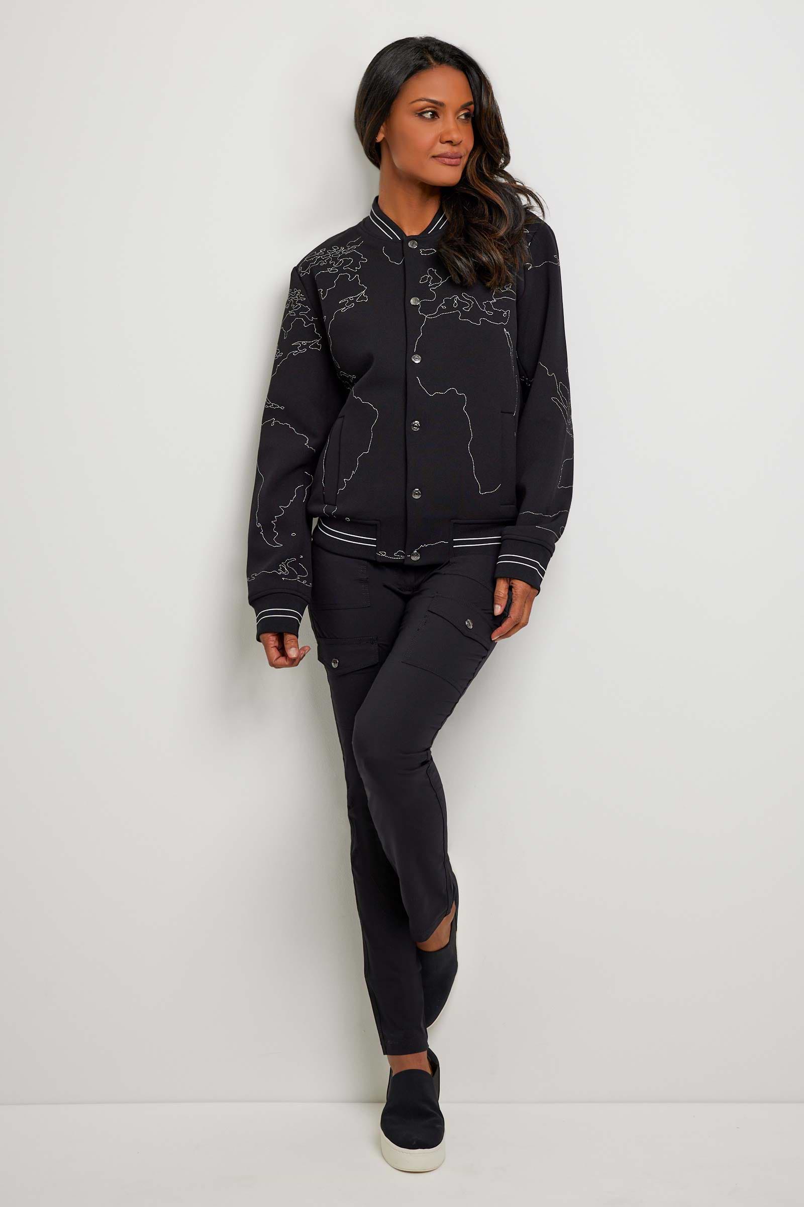 The Best Travel Jacket. Woman Showing the Front Profile of a Map Bomber Jacket in Black.