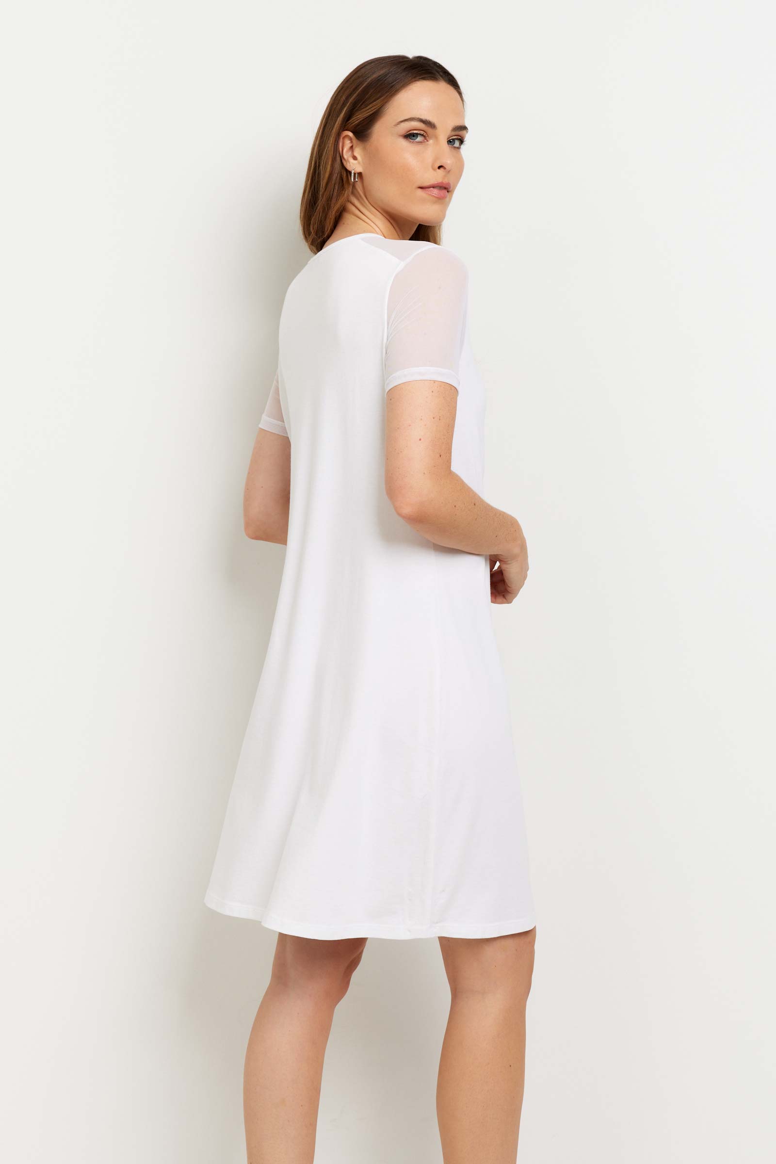 The Best Travel Dress. Woman Showing the Back Profile of a Melissa Dress in White.
