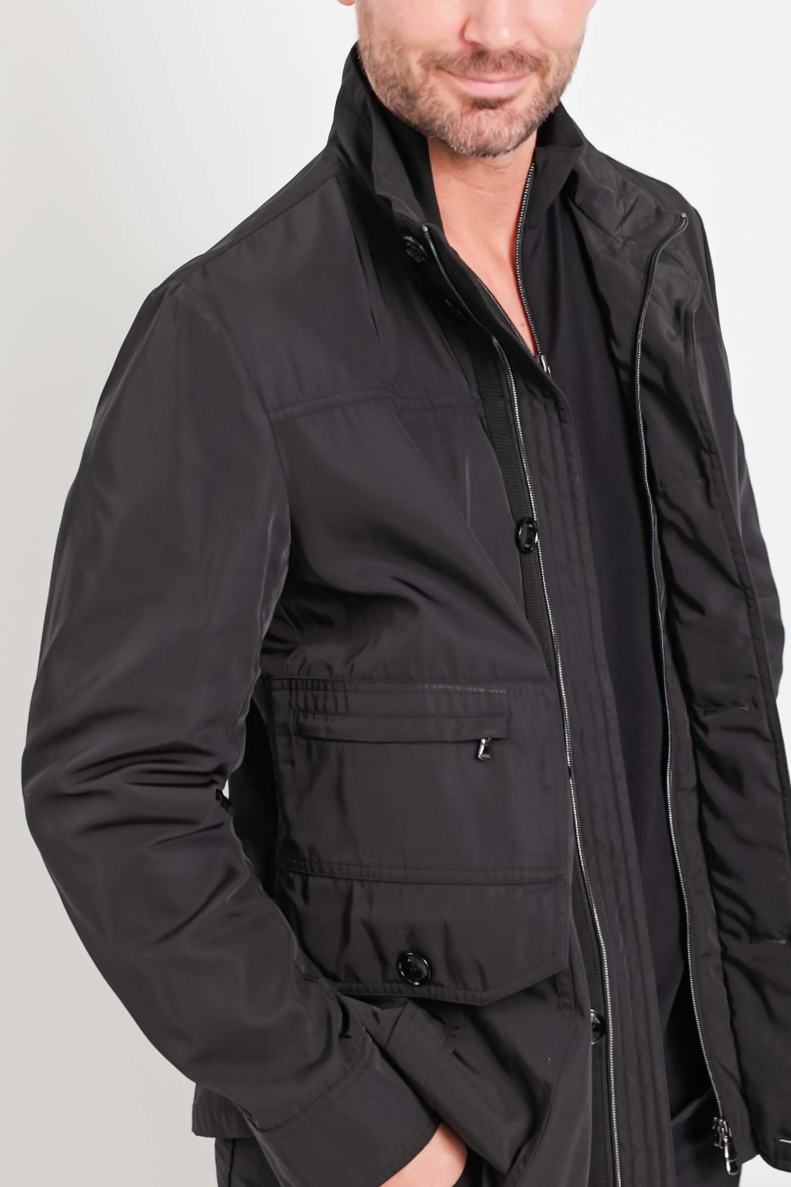 The Best Travel Jacket. Man Showing the Side Profile of a Men's Mike Jacket in Black.
