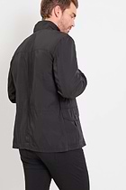 The Best Travel Jacket. Man Showing the Back Profile of a Men's Mike Jacket in Black.
