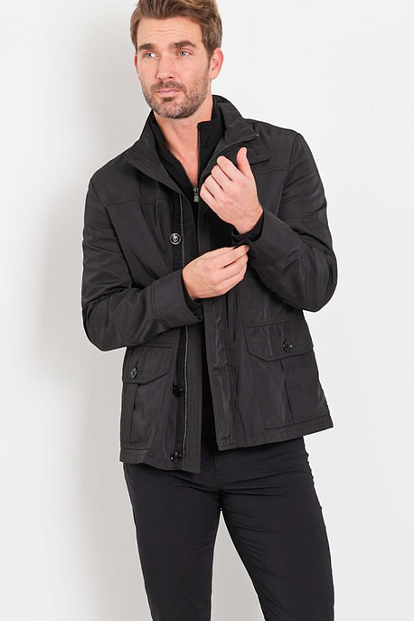 The Best Travel Jacket. Man Showing the Front Profile of a Men's Mike Jacket in Black.