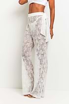 The Best Travel Pants. Woman Showing the Side Profile of a Moana Camo Mesh Pant in White.