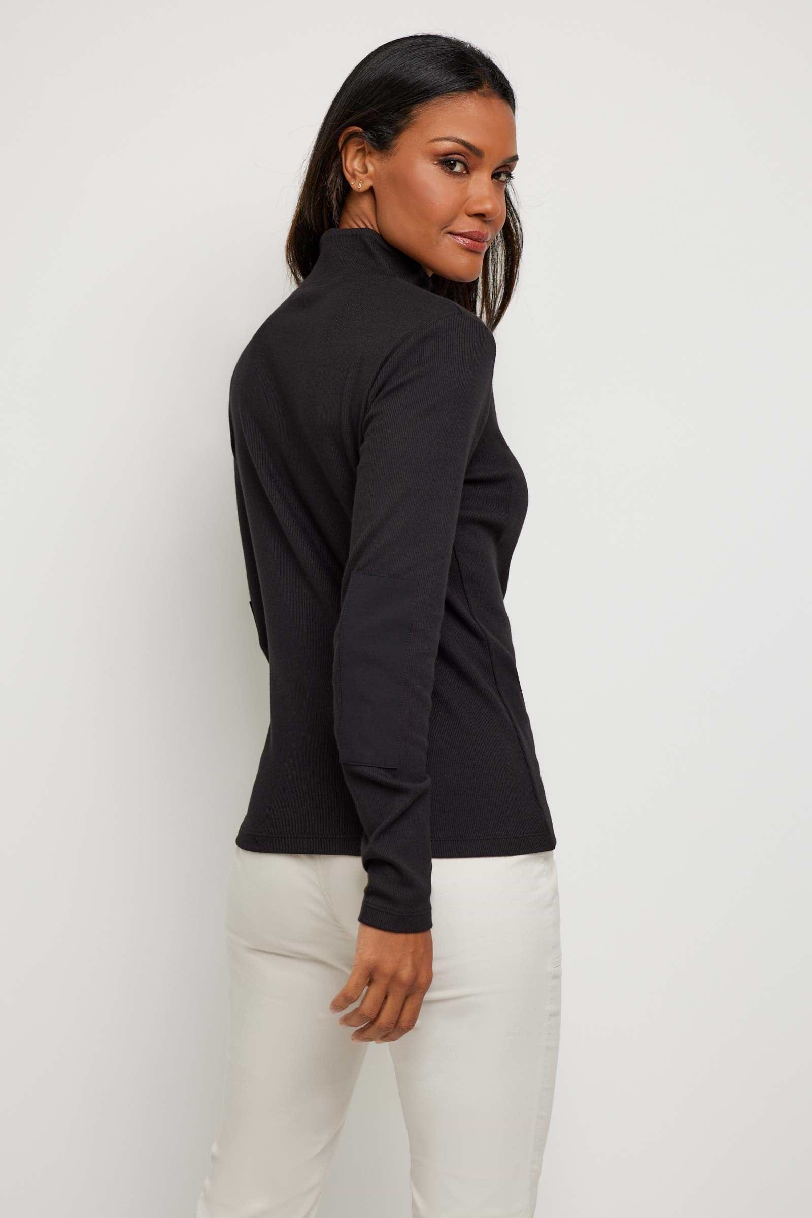 The Best Travel Top. Woman Showing the Back Side of a Monroe Henley Top in Black.