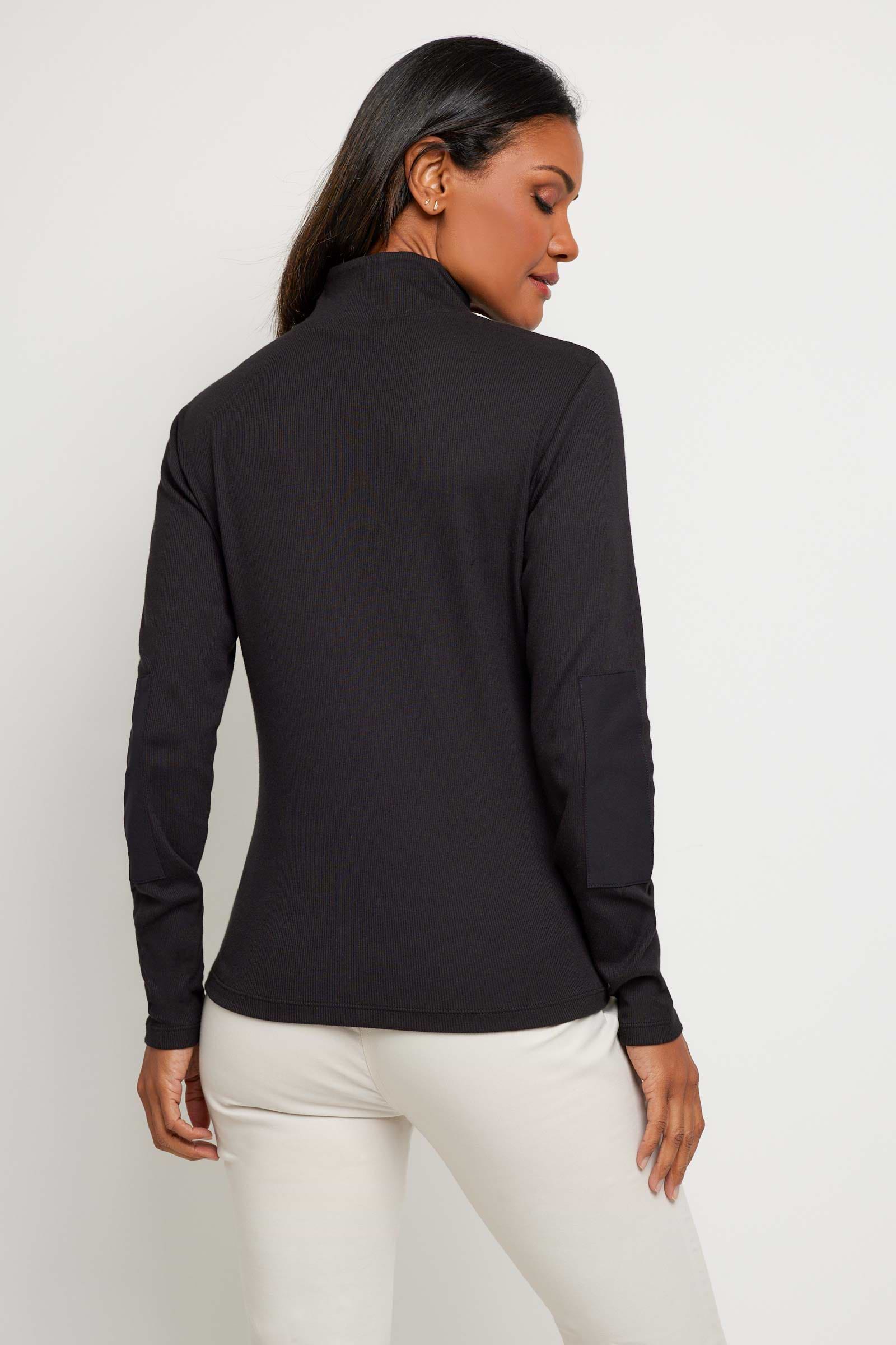 The Best Travel Top. Woman Showing the Back of a Monroe Henley Top in Black.
