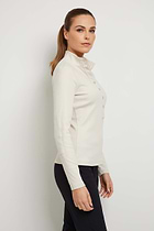 The Best Travel Top. Woman Showing the Side Profile of a Monroe Henley Top in Stone.