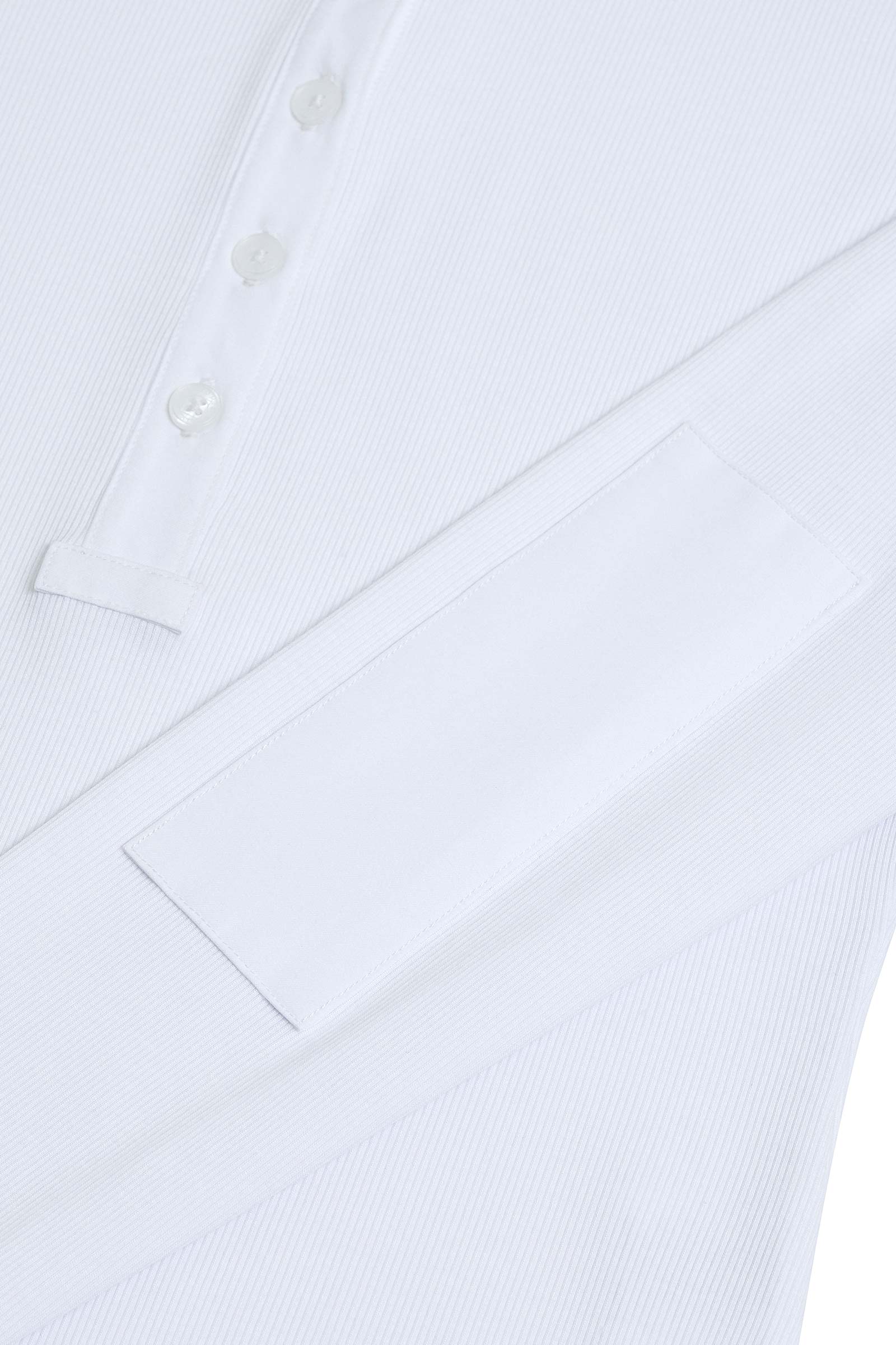 The Best Travel Top. Sleeve Detail of a Monroe Henley Top in White.