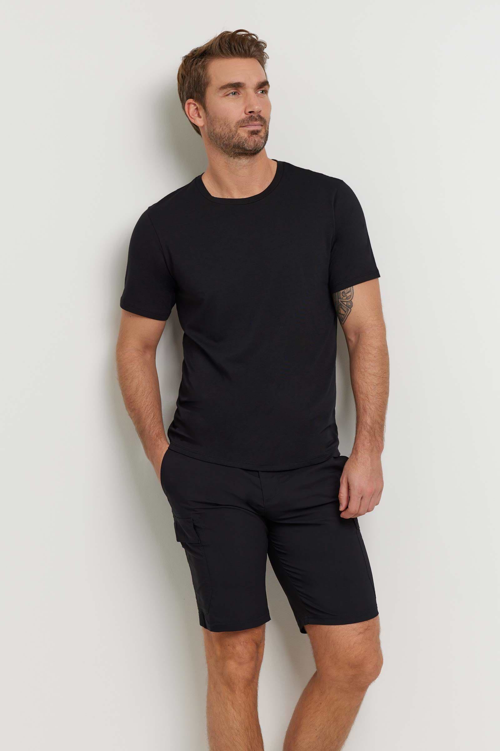 The Best Travel Top. Man Showing the Front Profile of a Men's Scott Top in Black.