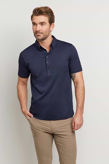 The Best Travel Top. Man Showing the Front Profile of a Men's Ryan Polo in Navy.