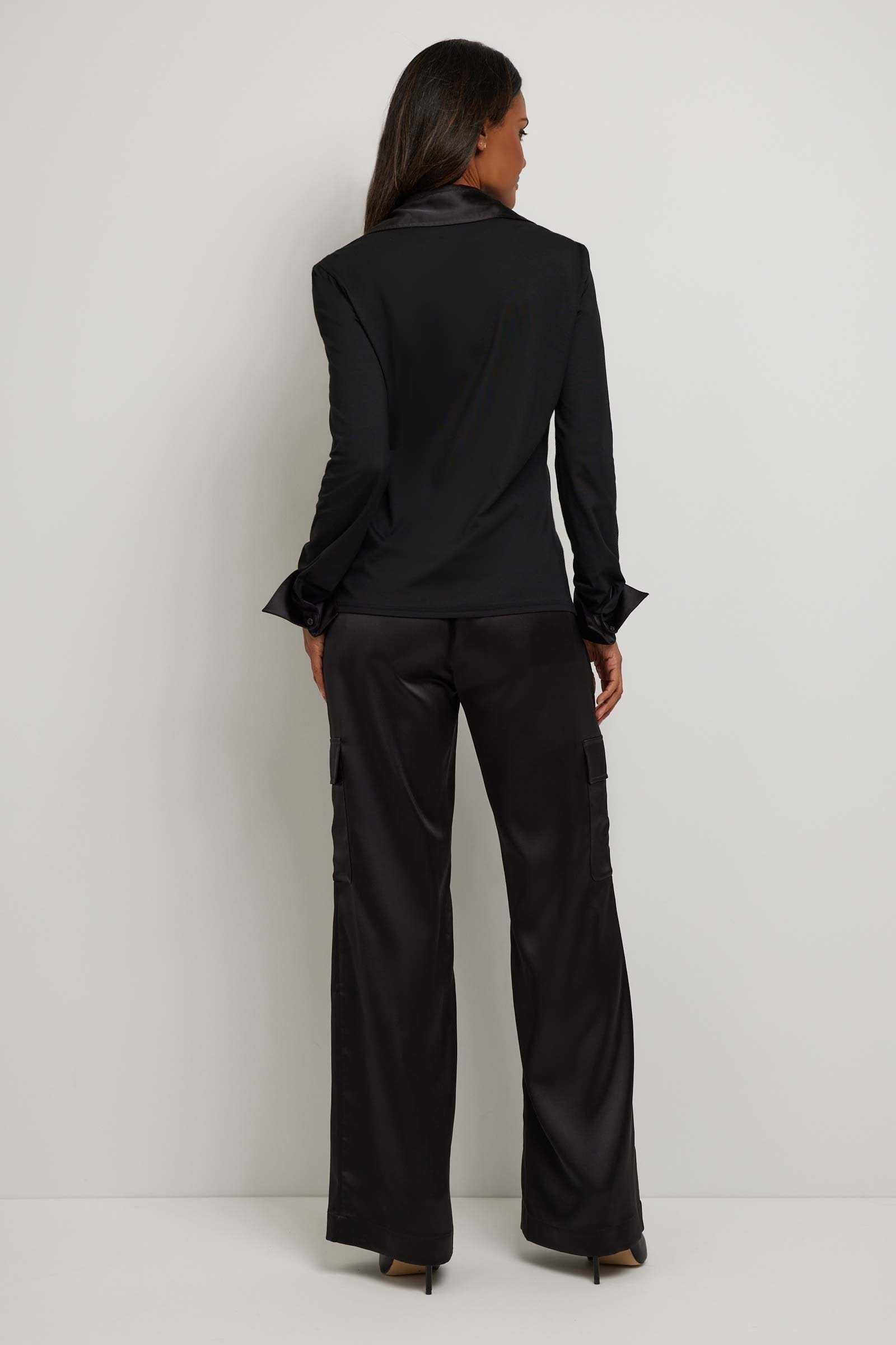 The Best Travel Top. Woman Showing the Back Profile of a Sadie Button Up Top in Black.