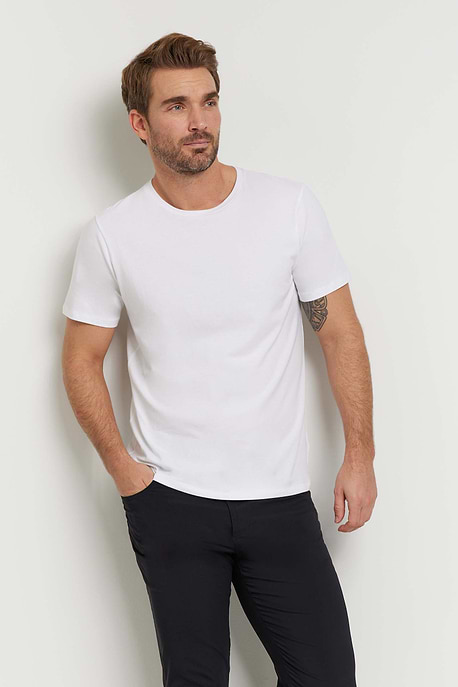 The Best Travel Top. Man Showing the Front Profile of a Men's Scott Top in White.
