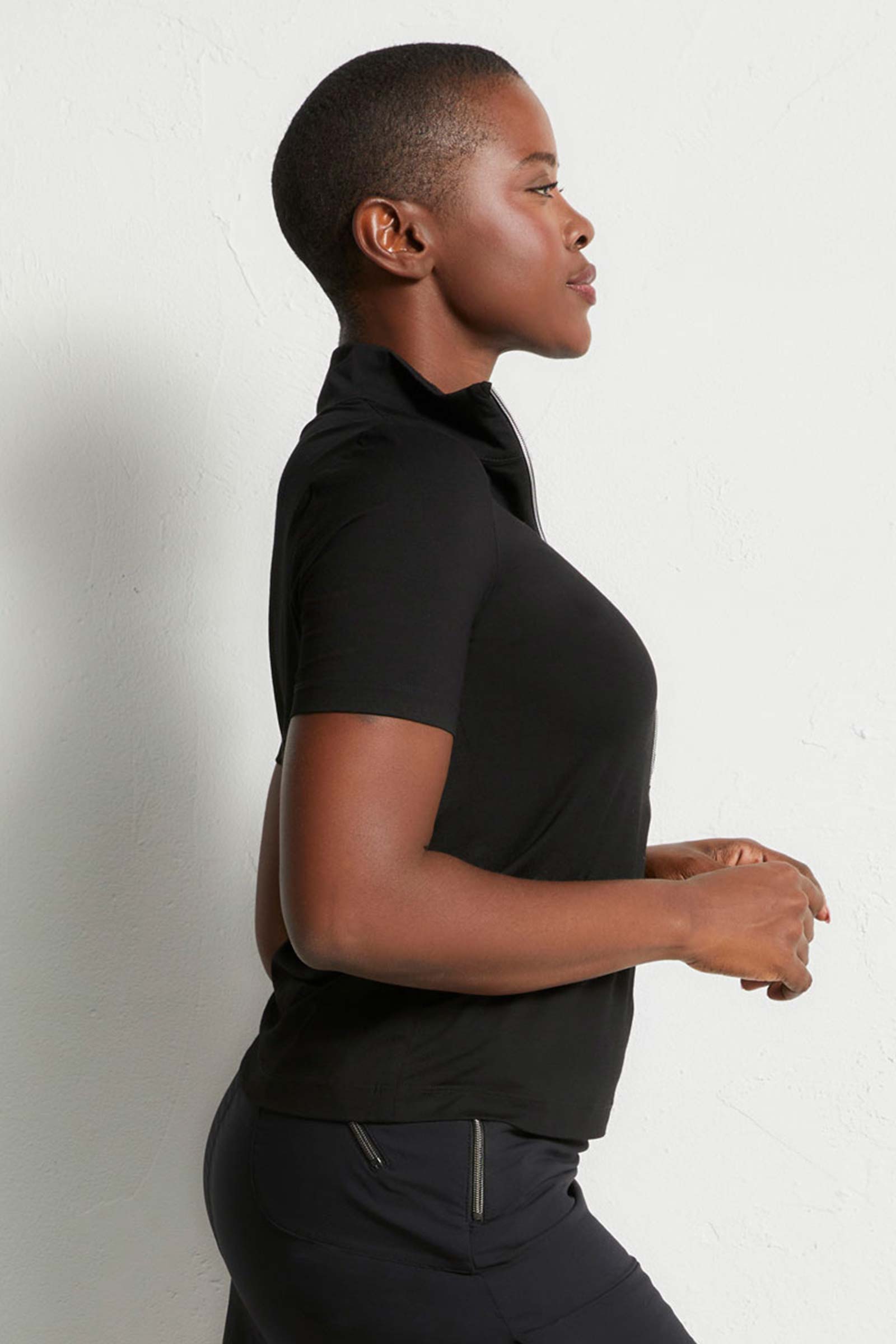 The Best Travel Top. Woman Showing the Side Profile of a Serena Top in Black.
