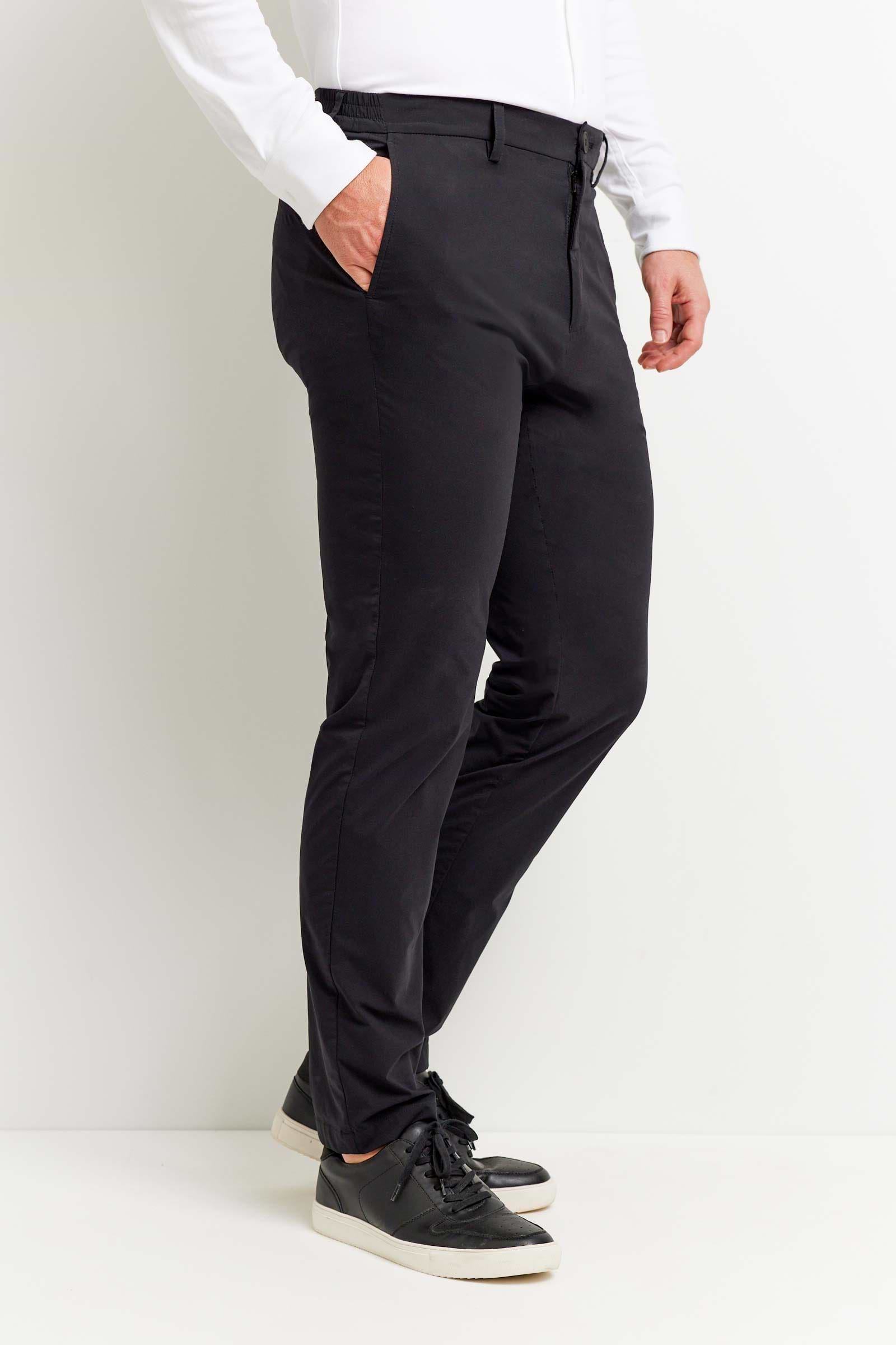 The Best Travel Pant. Man Showing the Side Profile of a Men's Stewart Pant in Black.