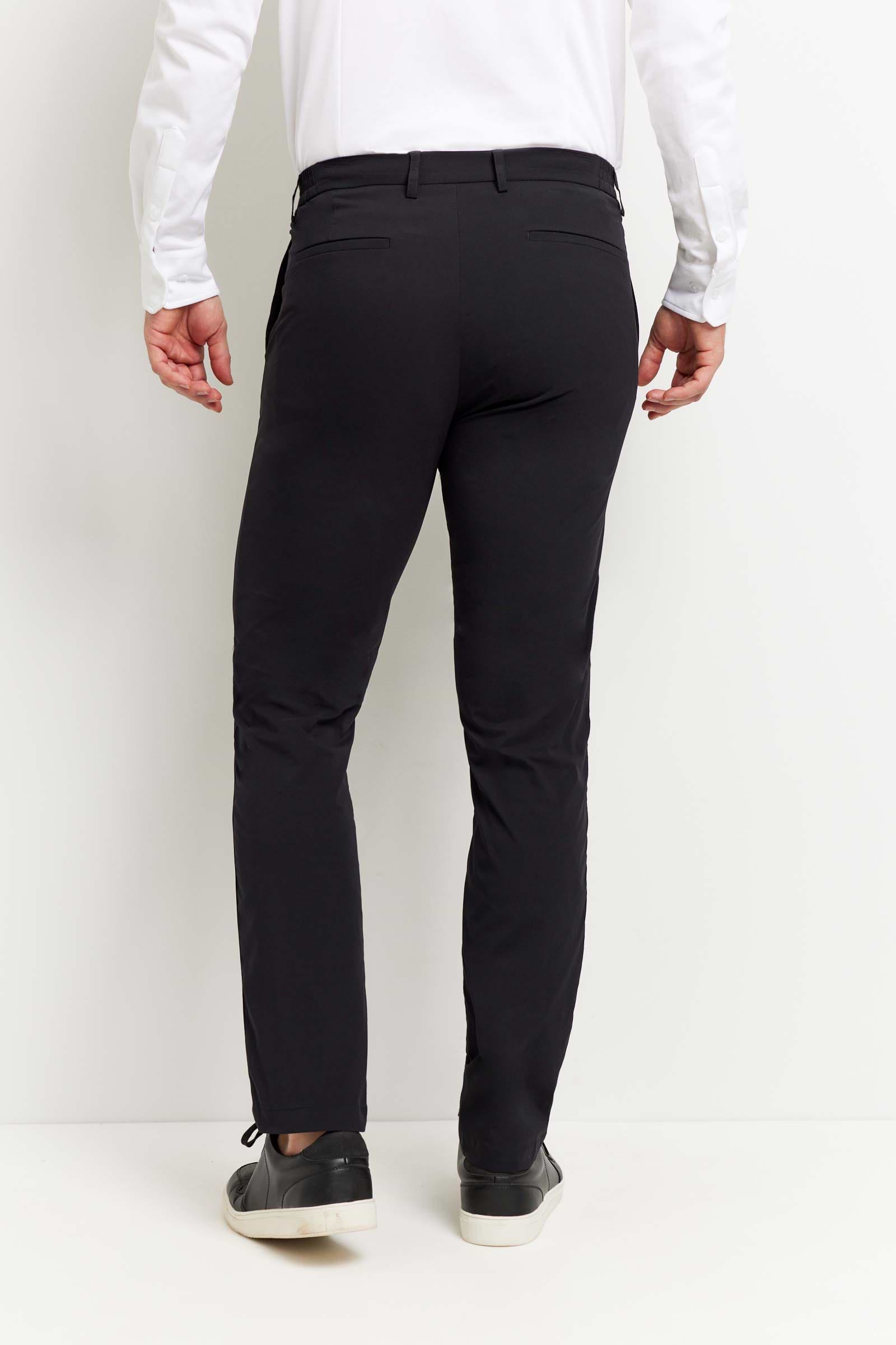 The Best Travel Pant. Man Showing the Back Profile of a Men's Stewart Pant in Black.