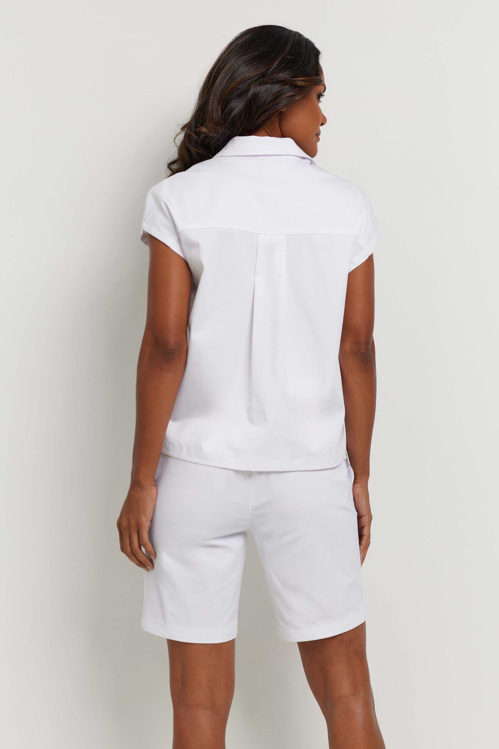 The Best Travel Top. Woman Showing the Back Profile of a Trixie Techno Poplin Top in White.