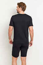 The Best Travel Top. Man Showing the Back Profile of a Men's Vince Top in Black.