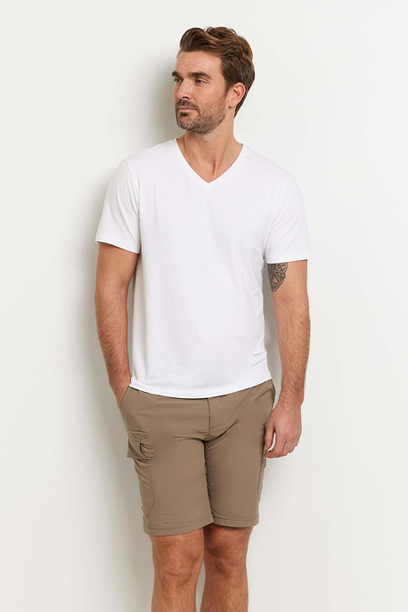 The Best Travel Top. Man Showing the Front Profile of a Men's Vince Top in White.