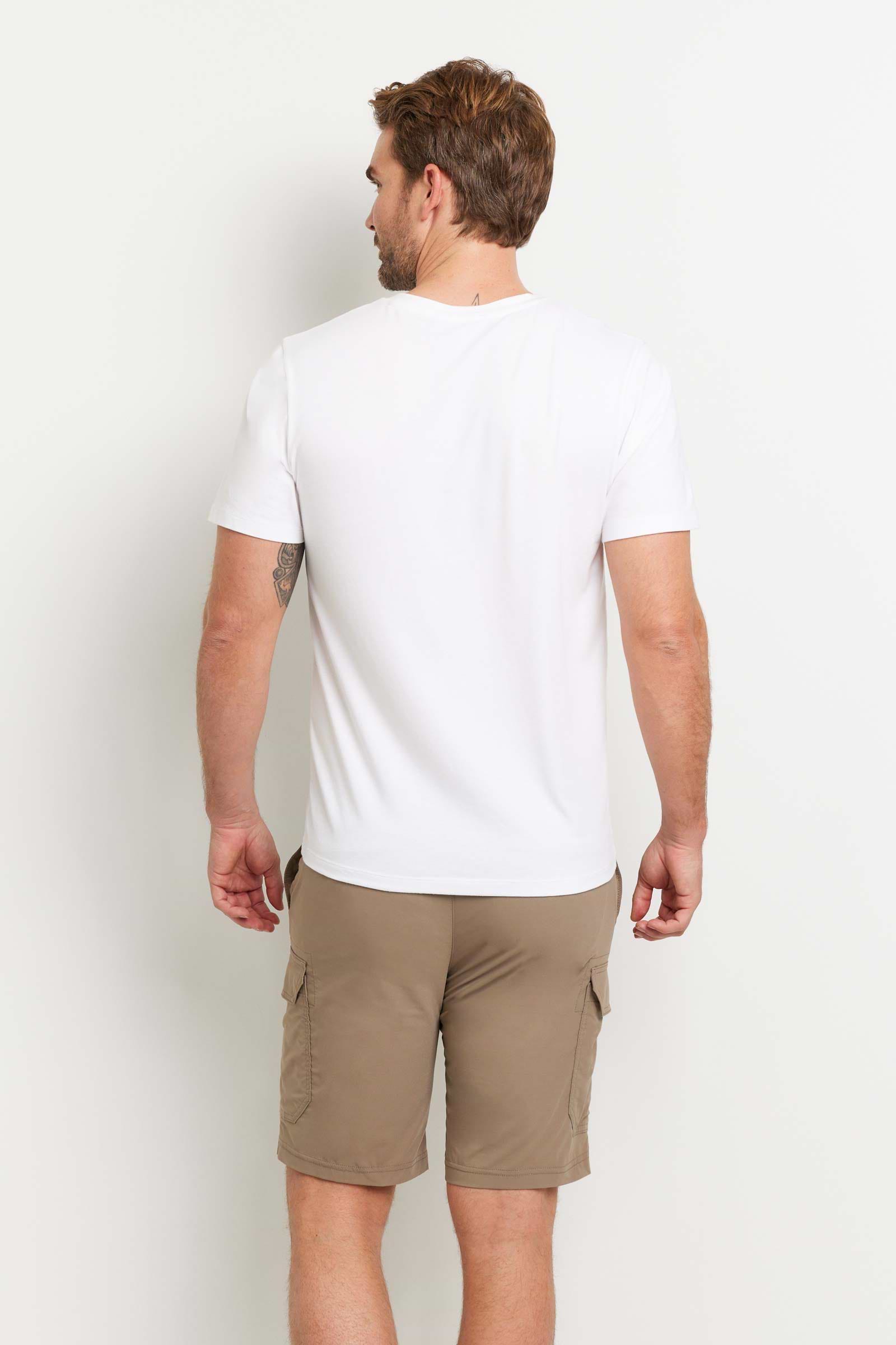 The Best Travel Top. Man Showing the Back Profile of a Men's Vince Top in White.