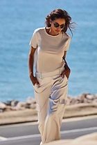 The Best Travel Pant. Lifestyle Image of a Candela Satin Pant in Stone.