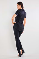The Best Travel Top. Woman Showing the Back Profile of a Helia Top in Black.