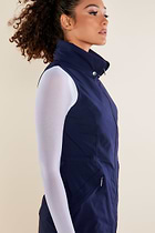 The Best Travel Vest. Woman Showing the Side Profile of a Delaney Travel Vest in Navy