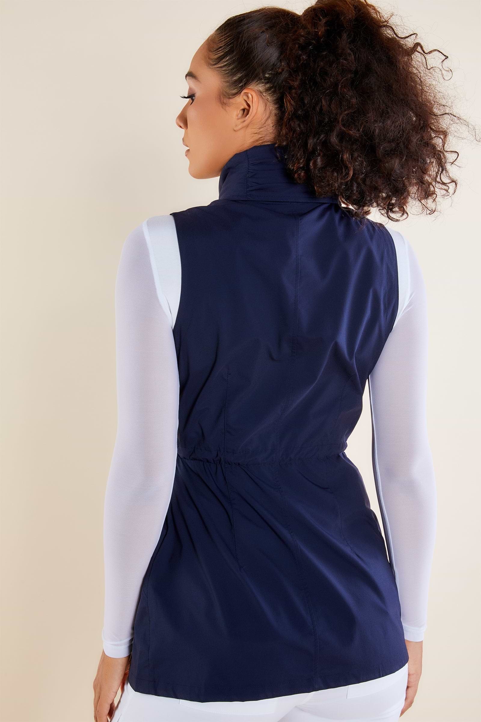 The Best Travel Vest. Woman Showing the Back Profile of a Delaney Travel Vest in Navy