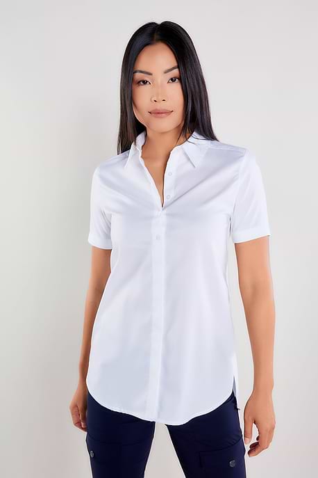 The Best Travel Top. Woman Showing the Front Profile of a Helia Top in White.