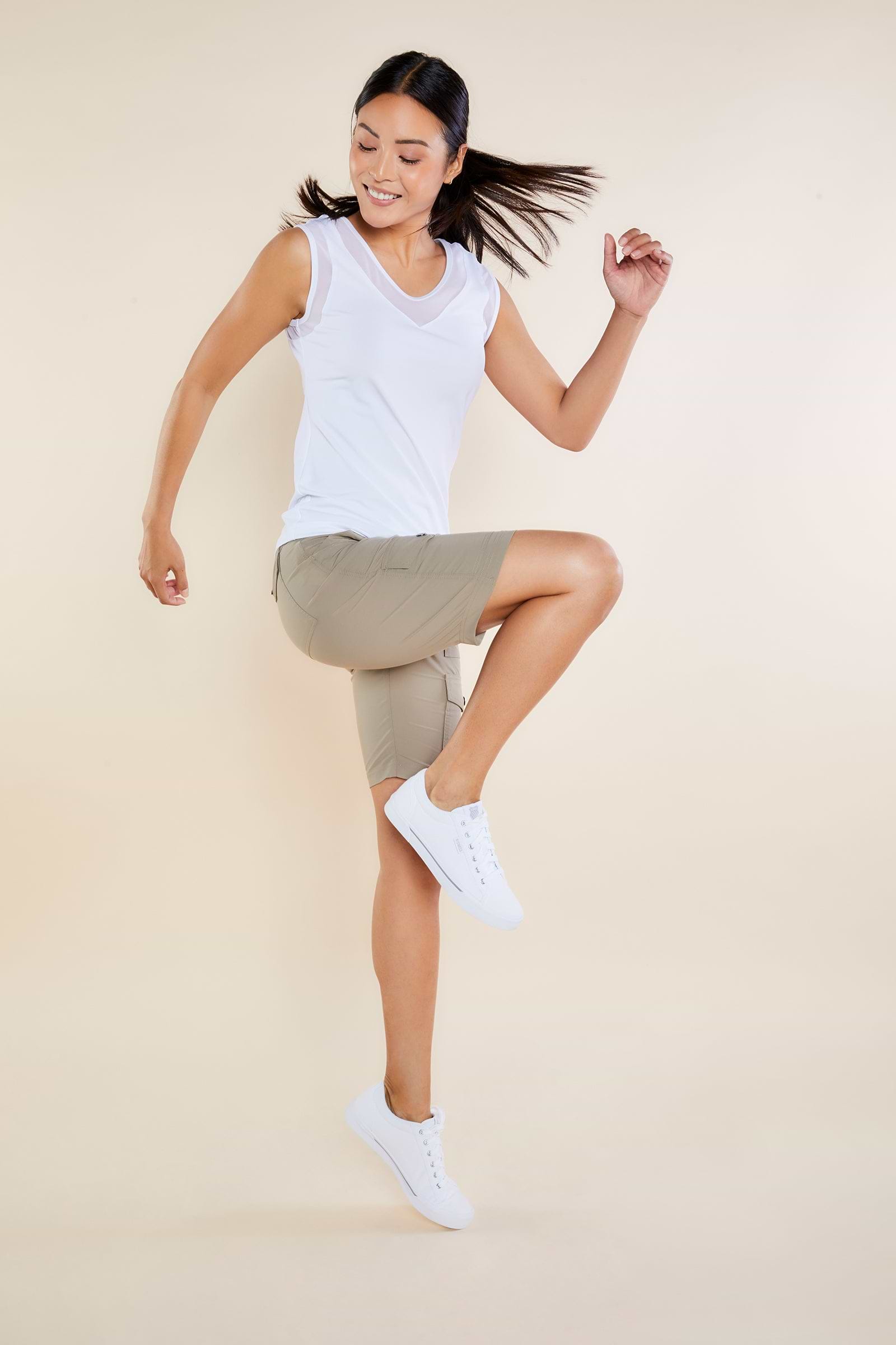 The Best Travel Shorts. Woman Showing the Side Profile of an Apiedi Shorts in Khaki.