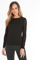 The Best Travel Top. Woman Showing the Front Profile of a Kim Mesh-Sleeve Top in Pima Modal in Black.