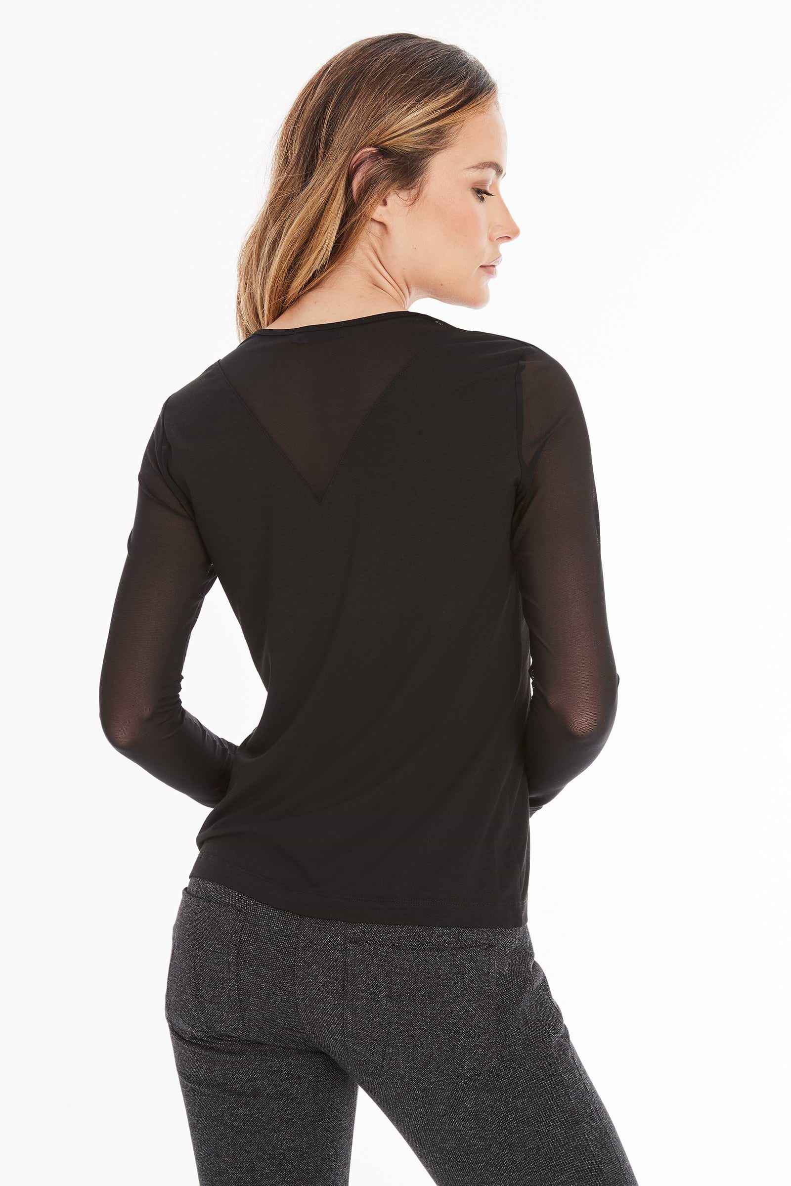 The Best Travel Top. Woman Showing the Back Profile of a Kim Mesh-Sleeve Top in Pima Modal in Black.