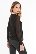 The Best Travel Top. Woman Showing the Side Profile of a Kim Mesh-Sleeve Top in Pima Modal in Black.