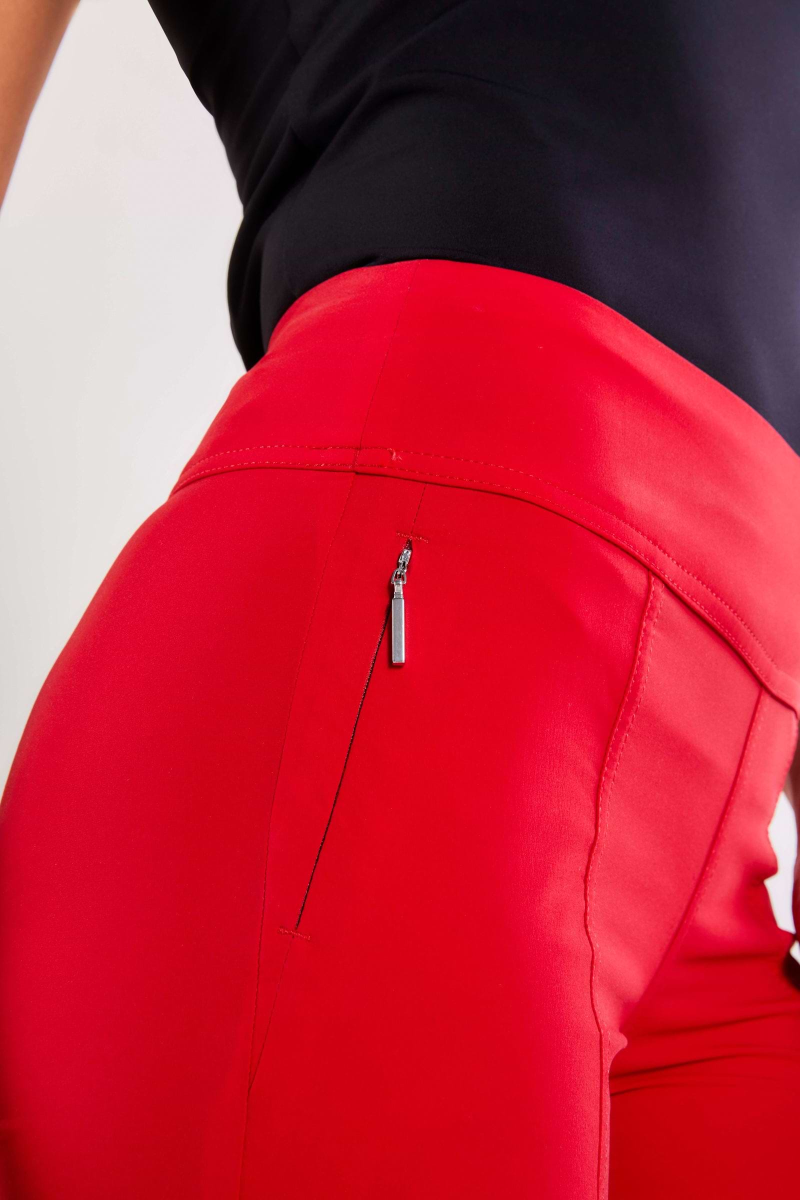 The Best Travel Pants. Front Zipper Pocket of the Allie Hybrid Pant in Atomic Red