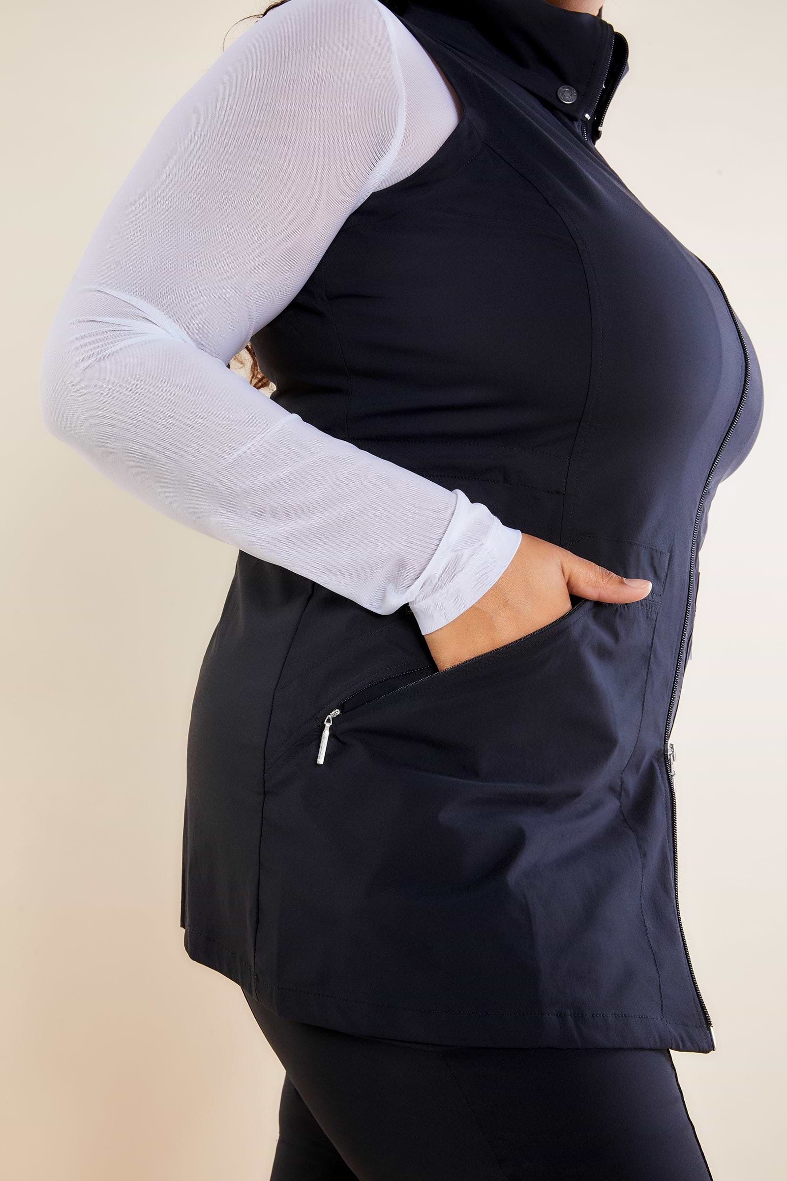 The Best Travel Vest. Woman Showing the Side Profile of a Delaney Travel Vest in Black