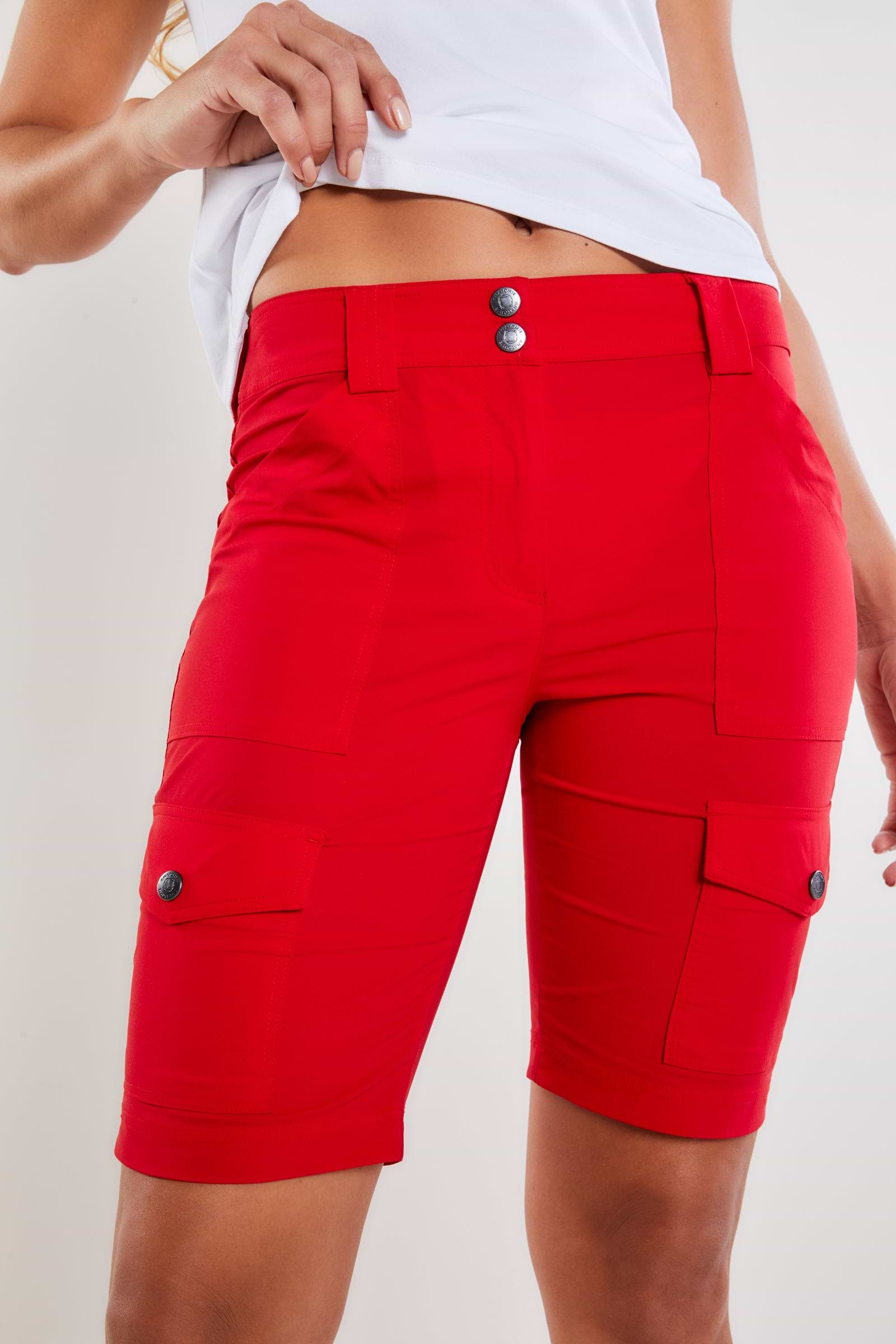 The Best Travel Shorts. Woman Showing the Front Profile of an Apiedi Shorts in Atomic Red.