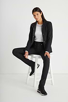The Best Travel Fleece-Lined Jacket. Seated Woman Showing the Front Profile of a Kenya Cozy Fleece-Lined Jacket in Black