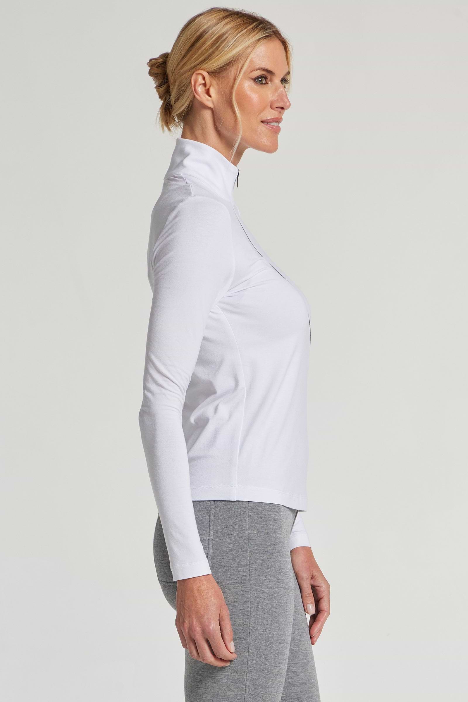 The Best Travel Top. Woman Showing the Side Profile of a Stacey Top in White.