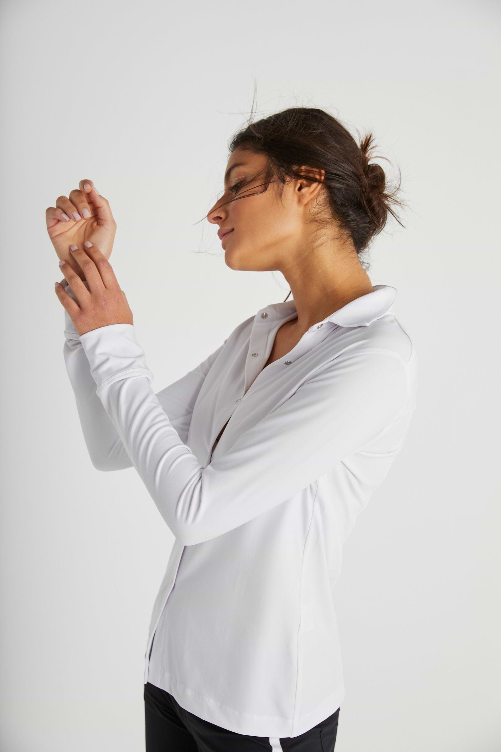 The Best Travel Top. Woman Showing the Side Profile of a Danica Snap On Super Jersey Top in White