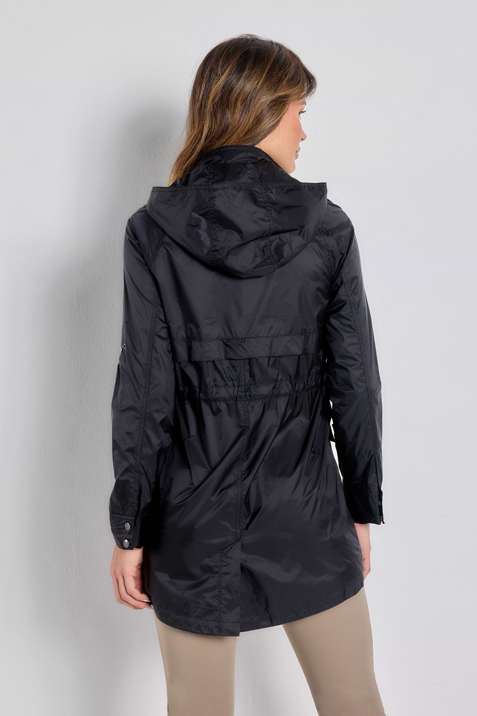 The Best Travel Jacket. Woman Showing the Back Profile of a Ramona Windbreaker Jacket in Black.