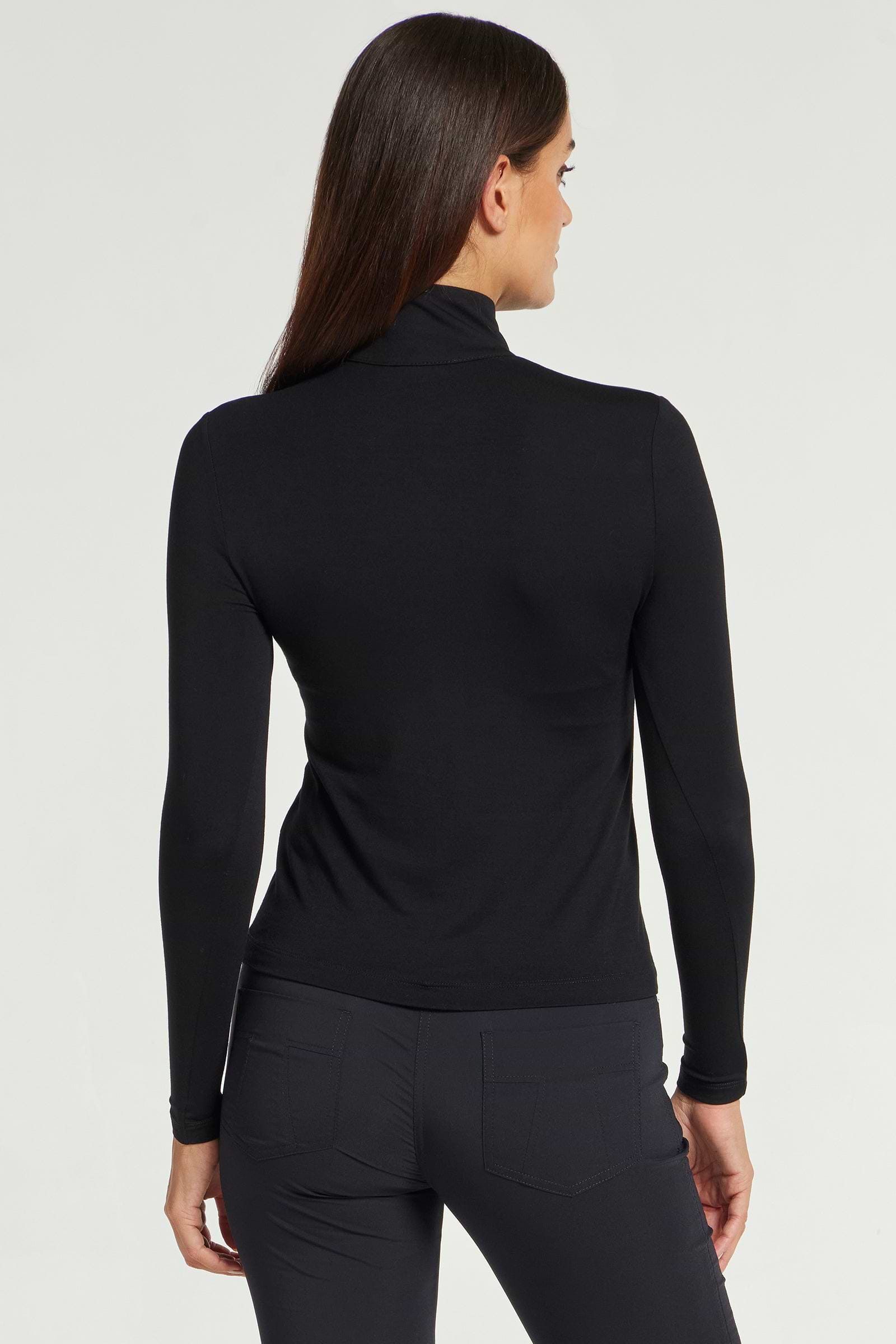 The Best Travel Top. Woman Showing the Back Profile of a Stacey Top in Black.
