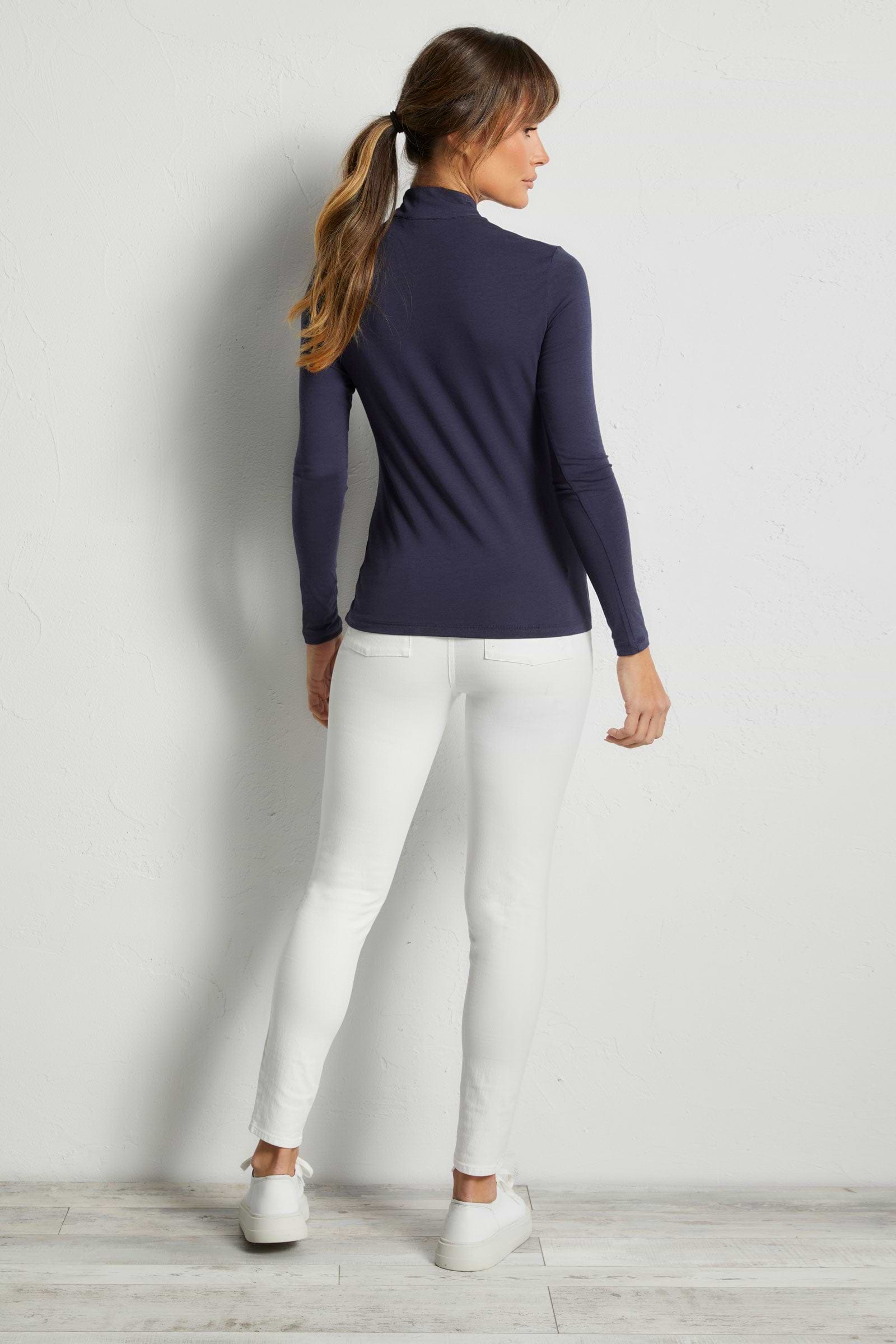 The Best Travel Top. Woman Showing the Back Profile of a Stacey Top in Navy.